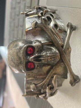 A Custom Made Skull & Crossbones Cuff Bracelet with red crystal eyes.